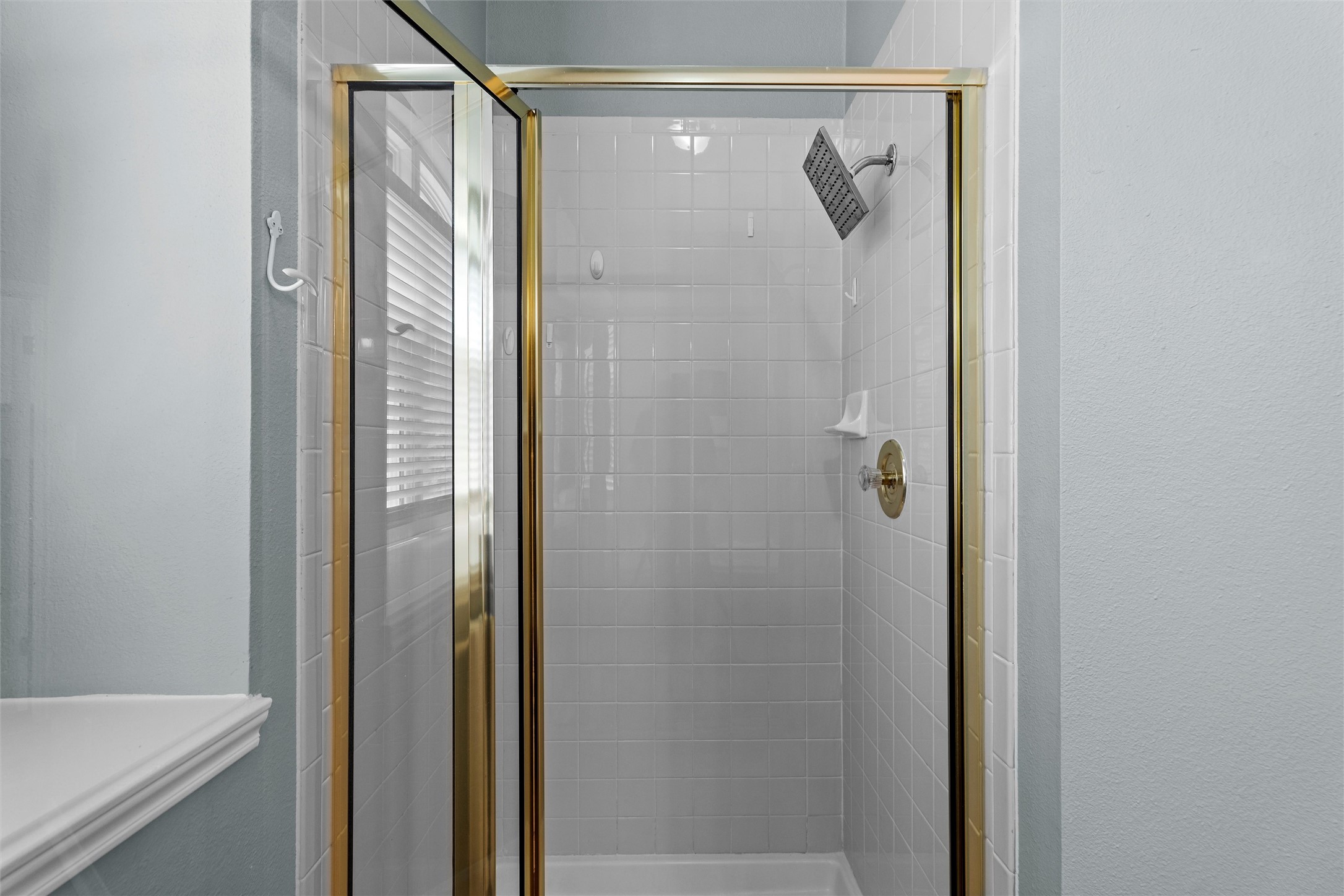 7000 Colberg Court Austin, TX 78749 - Photo 22 of 40 A pristine shower stall featuring classic tile work and a sleek, modern rain showerhead.