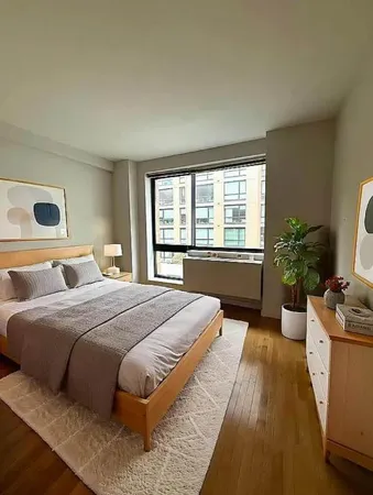 a bedroom with bed and a potted plant