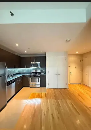 a large kitchen with stainless steel appliances a large counter top