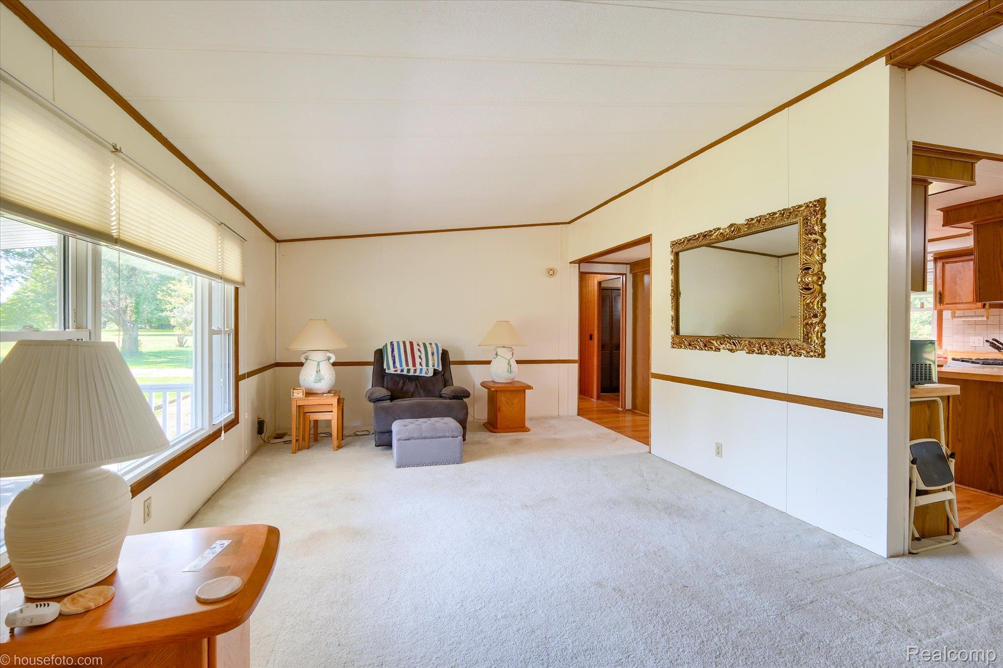 13566 Kaufman Road Capac, MI 48014 - Photo 8 of 50 Sitting room with crown molding and carpet floors