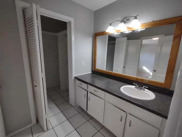 a bathroom with a double vanity sink and a mirror