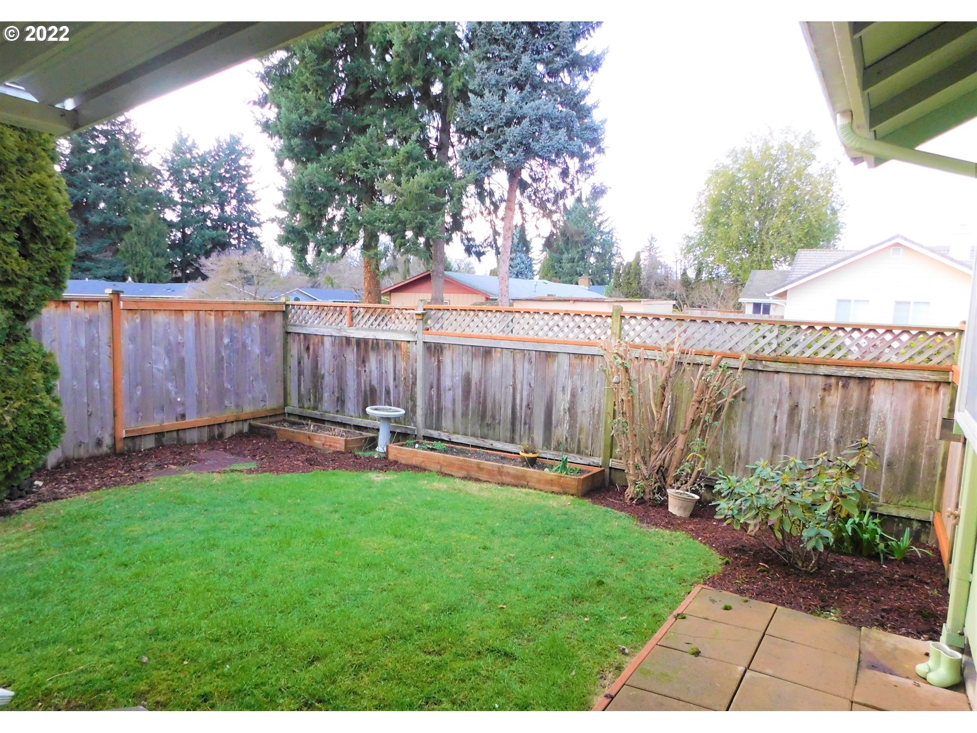 690 Poltava Street Springfield, OR 97477 - Photo 21 of 26 a view of a backyard with table and chairs and wooden fence