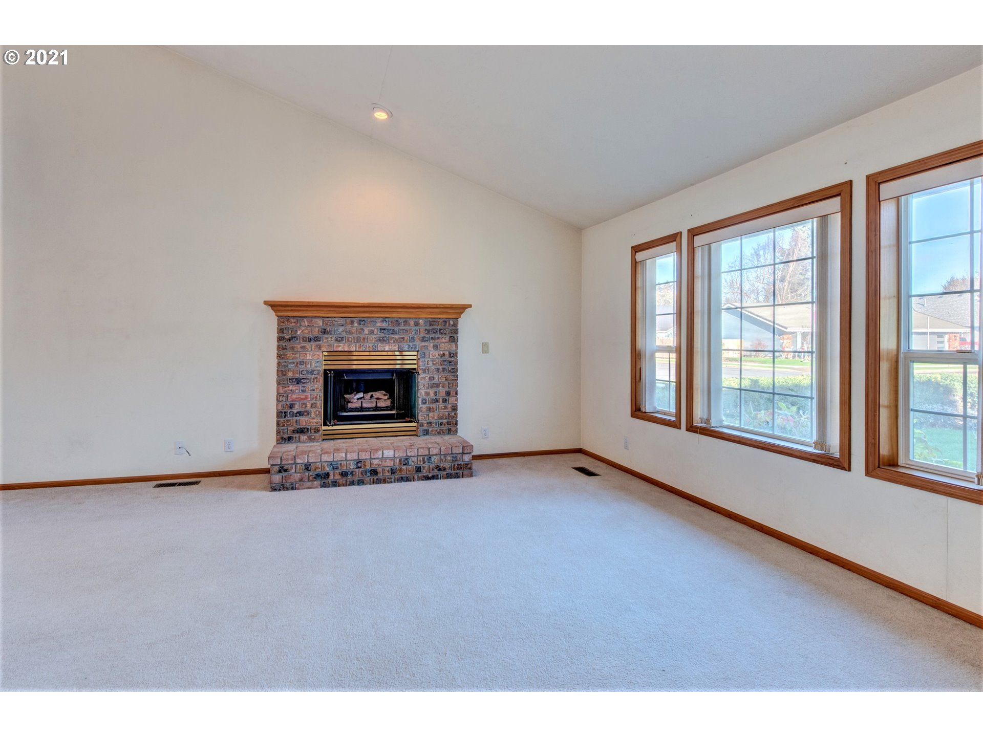 690 Poltava Street Springfield, OR 97477 - Photo 6 of 26 a view of an empty room with a fireplace and a window