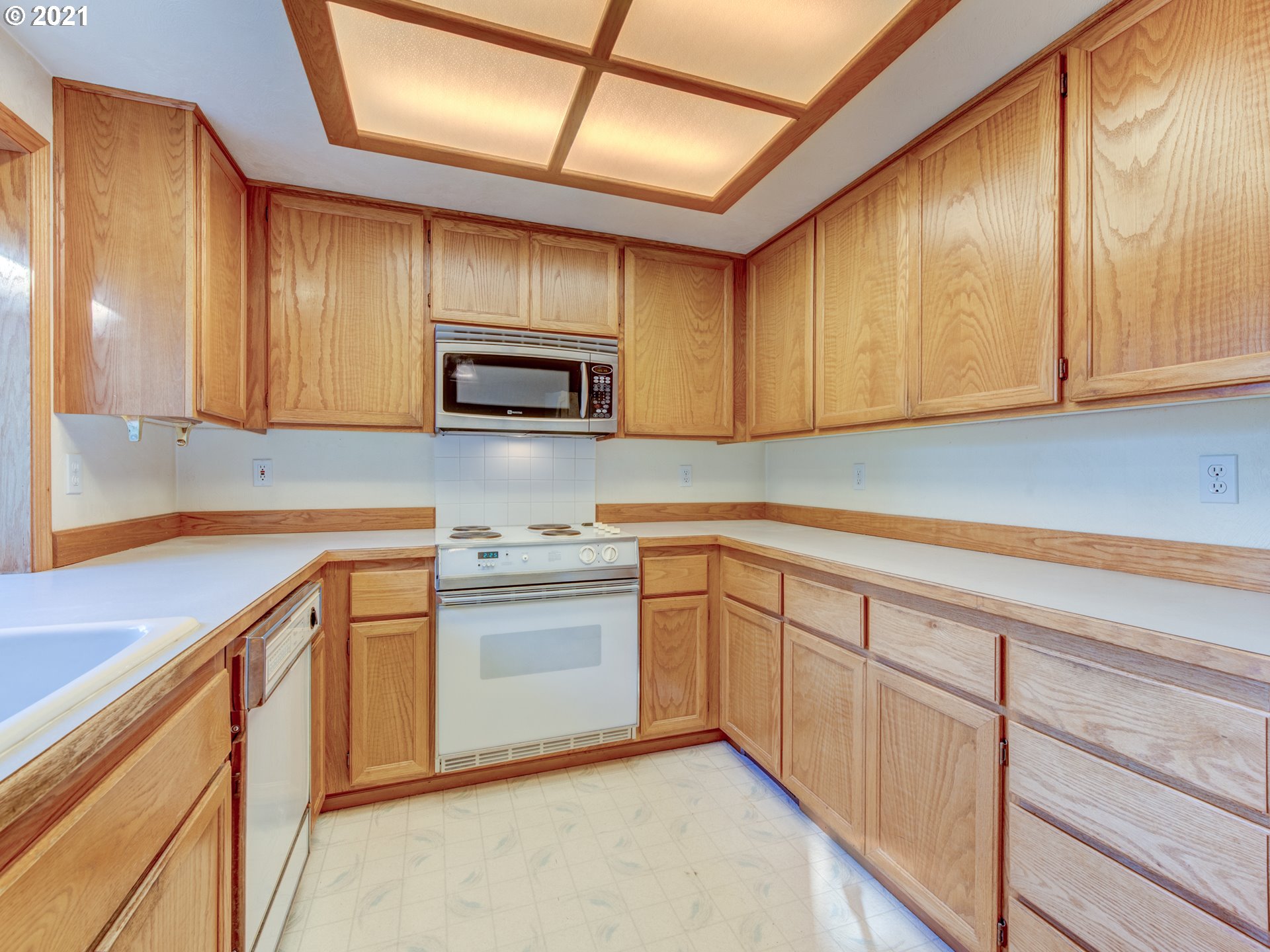 690 Poltava Street Springfield, OR 97477 - Photo 9 of 26 a kitchen with granite countertop white cabinets and stainless steel appliances