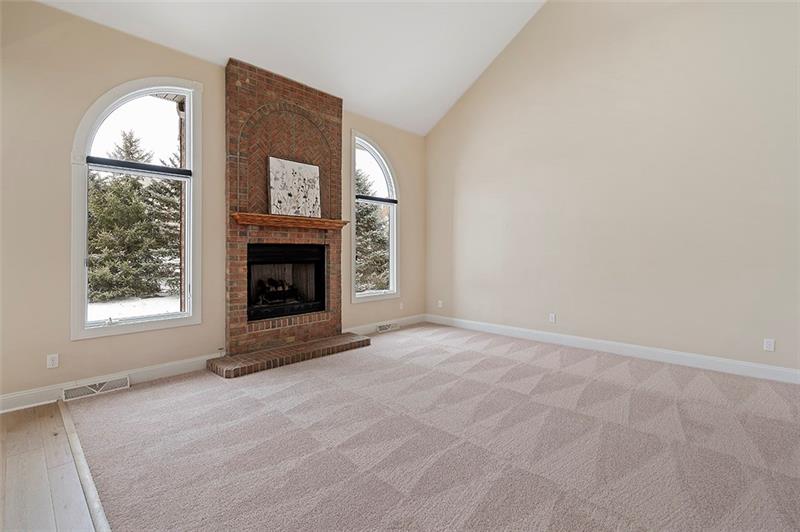 110 Rabold Drive Wexford, PA 15090 - Photo 7 of 25 The family room features a brick fireplace framed with arched windows.