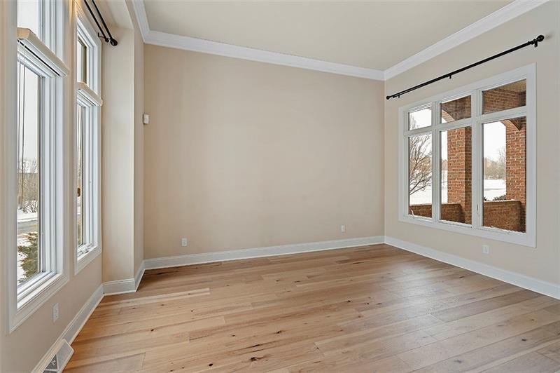 110 Rabold Drive Wexford, PA 15090 - Photo 10 of 25 Natural light flows into the living room which also is detailed with crown molding. It offers a view to both the outdoors and the covered patio.