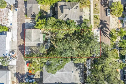 an aerial view of a house with a yard and garden