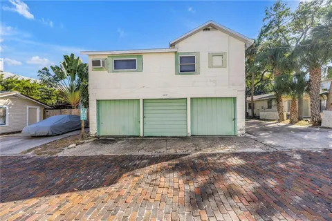 a view of a house with a yard and garage