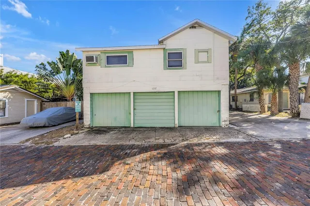 a view of a house with a yard and garage