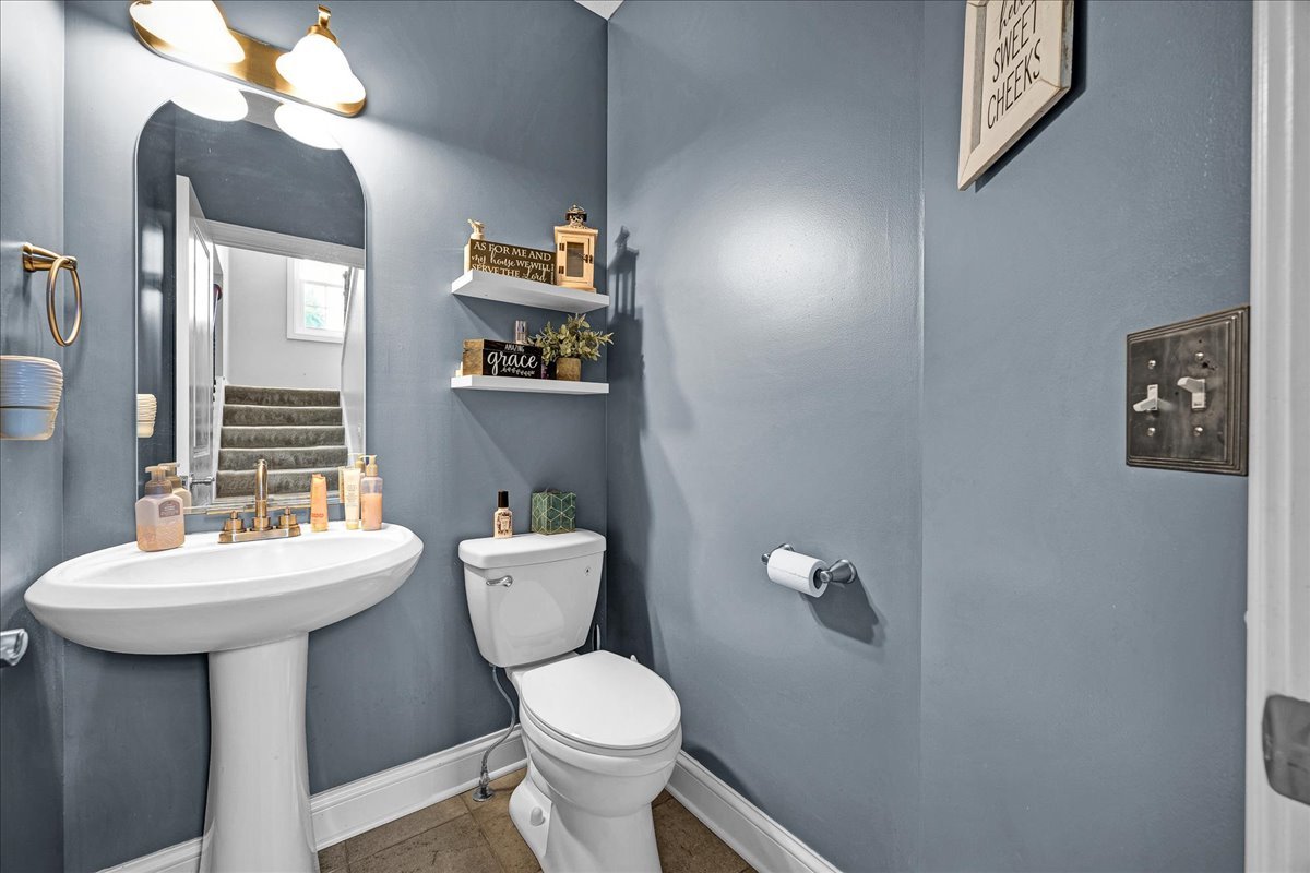 1001 Mugho Court Normal, IL 61761 - Photo 14 of 46 a bathroom with a toilet a sink and mirror