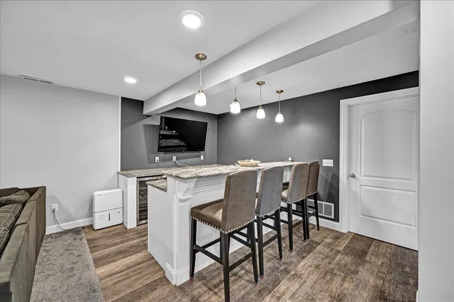 a kitchen with a table chairs refrigerator and microwave