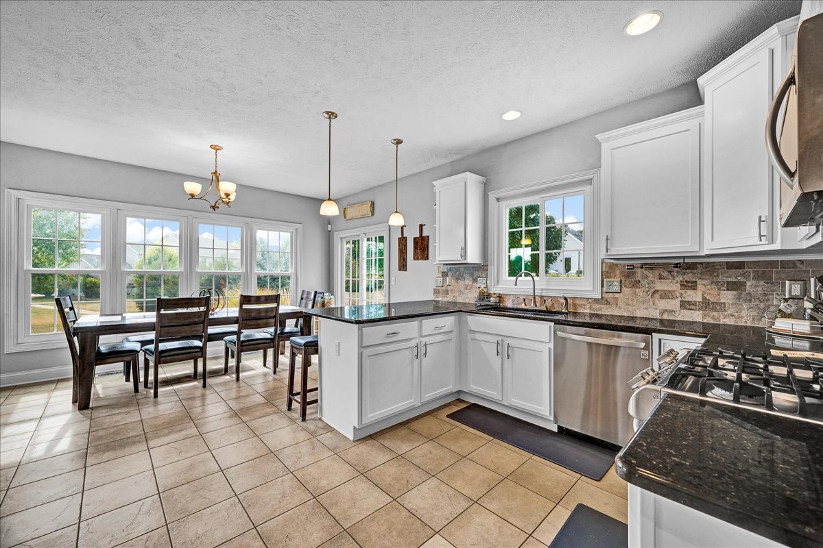 1001 Mugho Court Normal, IL 61761 - Photo 3 of 46 a kitchen with stainless steel appliances granite countertop sink stove top oven and cabinets