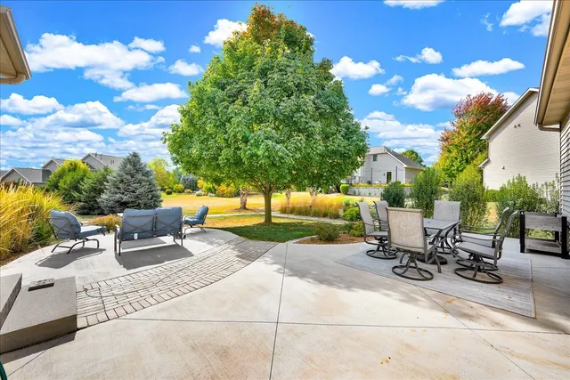a view of a backyard with sitting area
