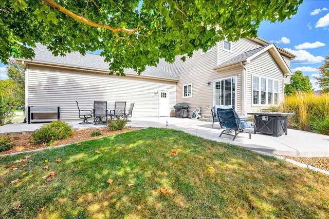 a view of a house with backyard and sitting area
