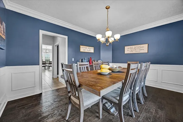 a view of a dining room with furniture and chandelier