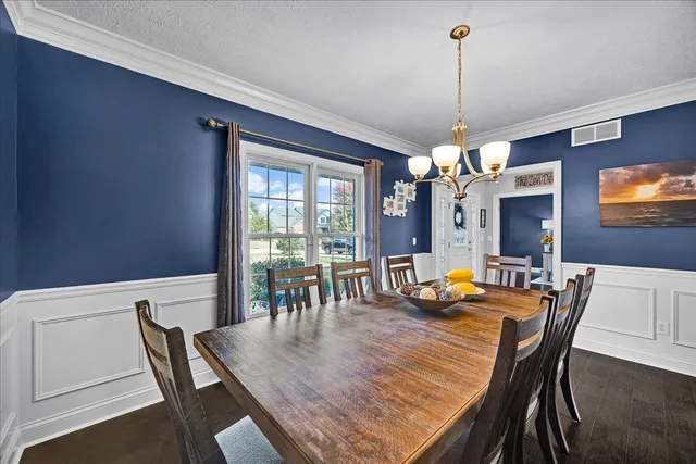 a dining room with furniture a chandelier and window