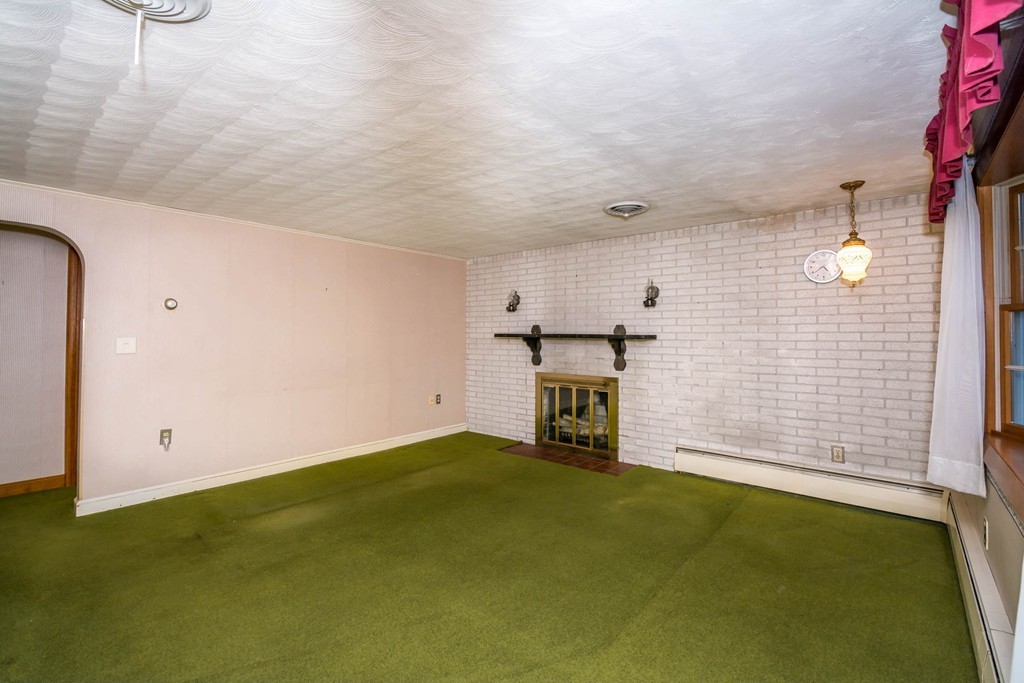 77 Sturges Road Reading, MA 01867 - Photo 4 of 19 a view of empty room with a fireplace
