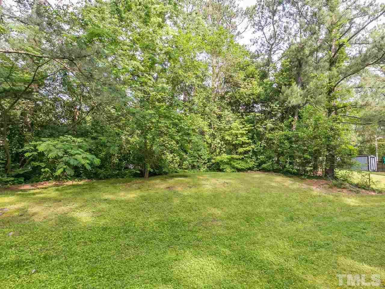 4813 Radcliff Road Raleigh, NC 27609 - Photo 22 of 22 a view of a big yard with an trees