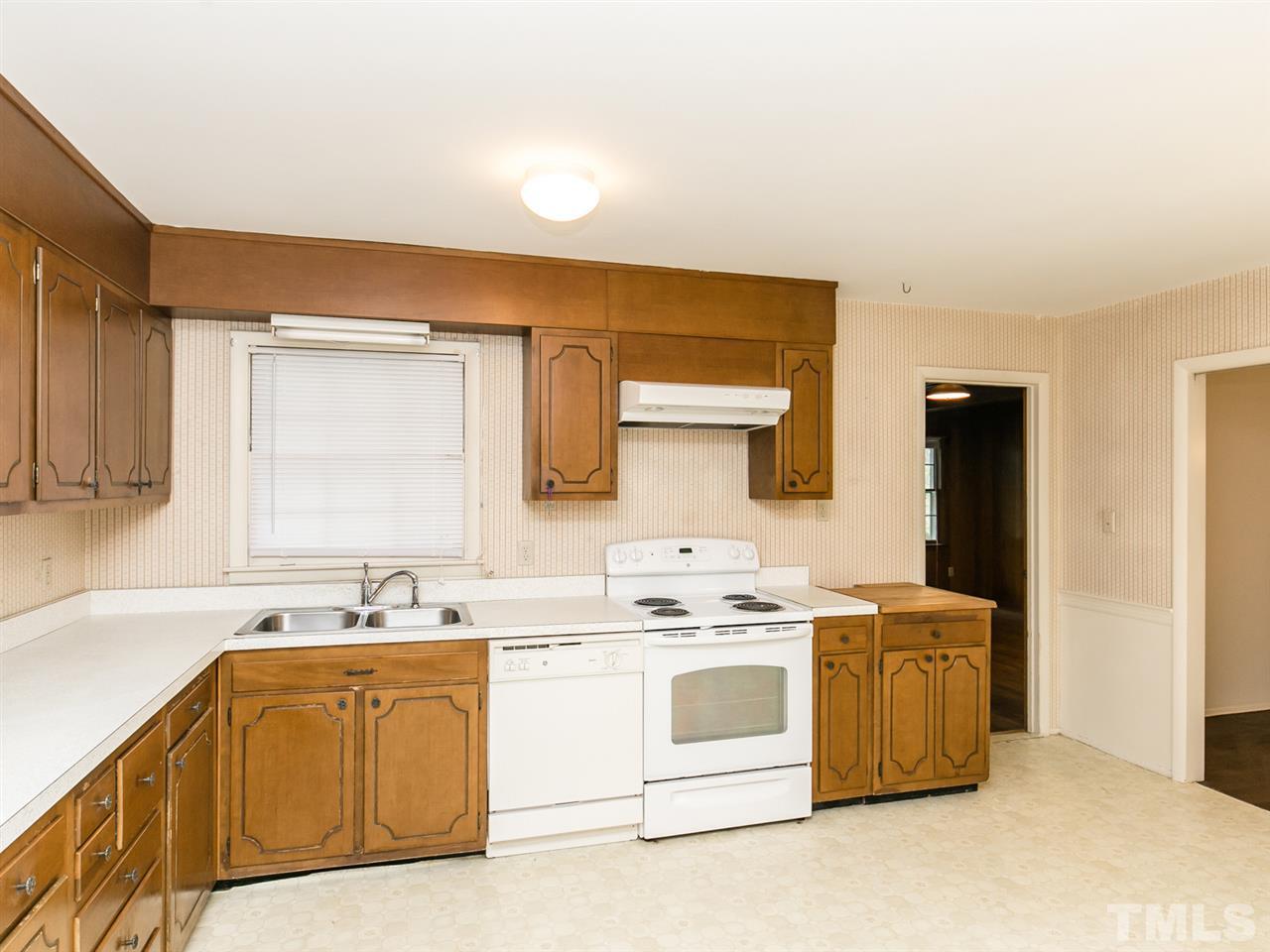 4813 Radcliff Road Raleigh, NC 27609 - Photo 4 of 22 a kitchen with stainless steel appliances a white stove top oven cabinets a sink and a window