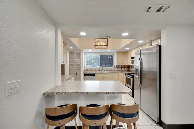 a living room with furniture and a ceiling fan