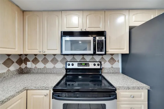 a backyard of a house with lots of green space and lake view