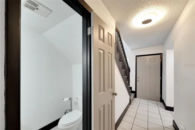 a bathroom with a granite countertop double vanity sink a mirror and a shower