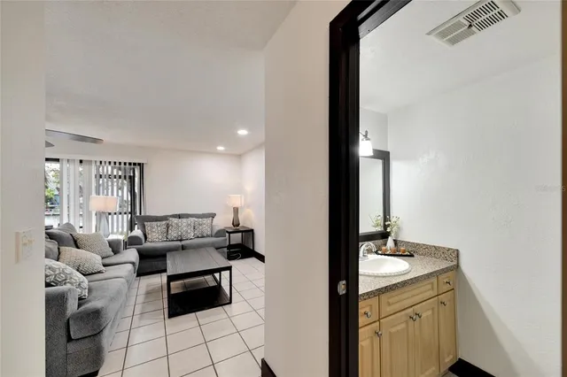 a bathroom with a granite countertop sink and mirror