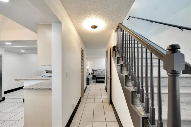 a kitchen with a table chairs and a refrigerator