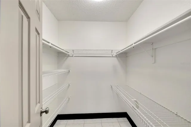 an aerial view of a house with a yard and lake view