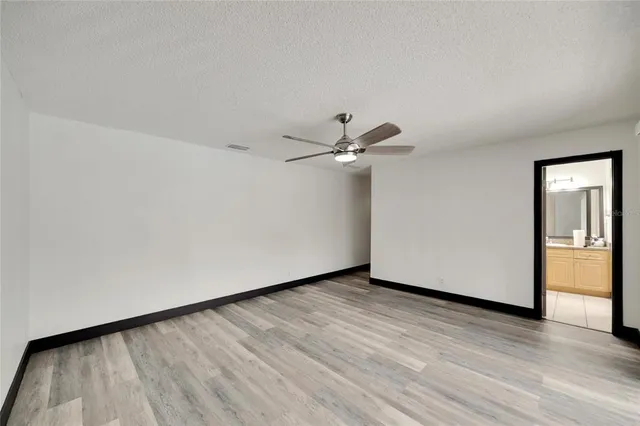an aerial view of residential houses with outdoor space and trees