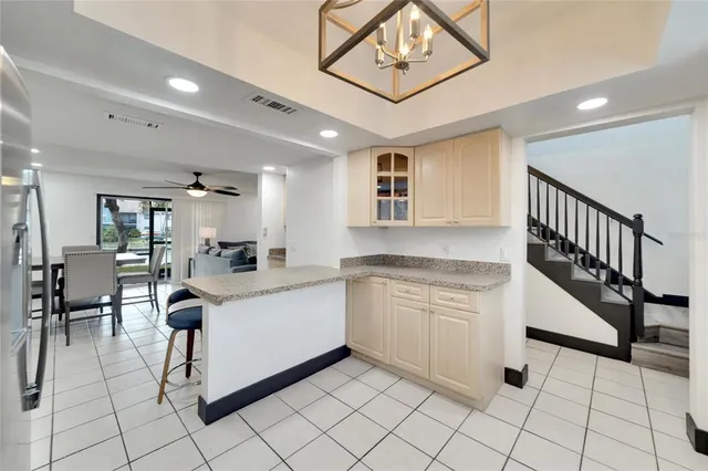 a view of a dining room with furniture and a chandelier