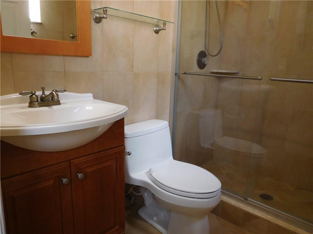 18897 Cloud Lake Circle Boca Raton, FL 33496 - Photo 16 of 23 a bathroom with a sink a toilet and shower