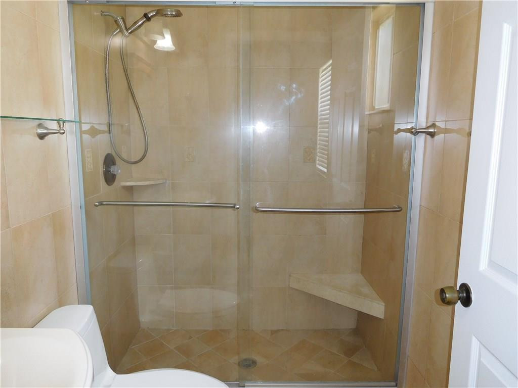 18897 Cloud Lake Circle Boca Raton, FL 33496 - Photo 17 of 23 a bathroom with a glass shower door