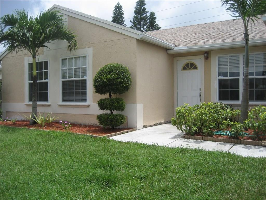 18897 Cloud Lake Circle Boca Raton, FL 33496 - Photo 2 of 23 a front view of a house with a yard and potted plants