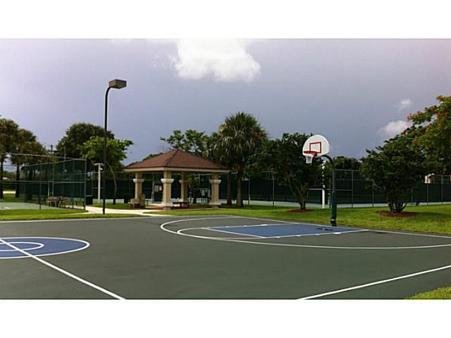 18897 Cloud Lake Circle Boca Raton, FL 33496 - Photo 21 of 23 a view of a tennis ground with large trees