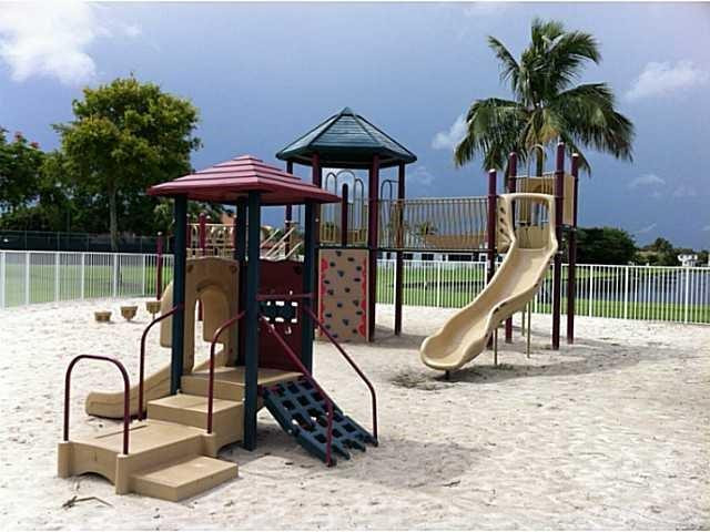 18897 Cloud Lake Circle Boca Raton, FL 33496 - Photo 23 of 23 a table and chair sitting under a umbrella