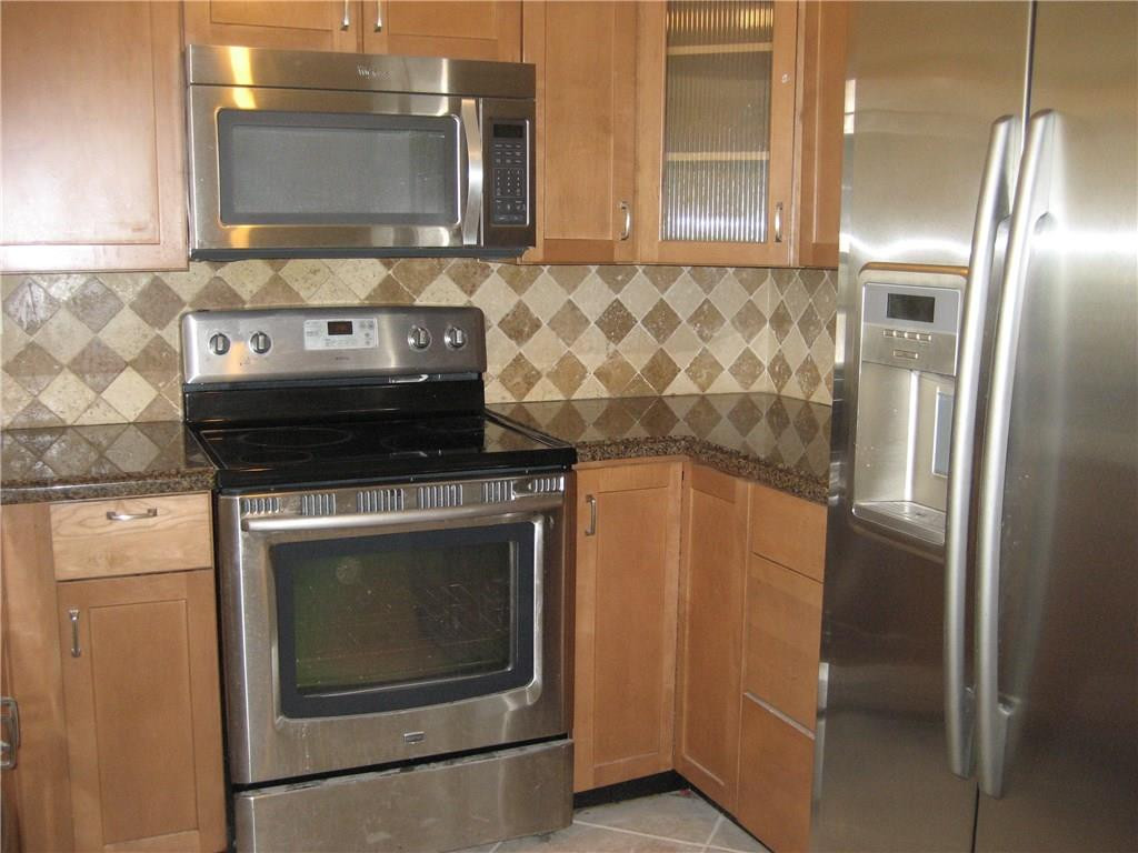 18897 Cloud Lake Circle Boca Raton, FL 33496 - Photo 3 of 23 a stove top oven sitting inside of a kitchen