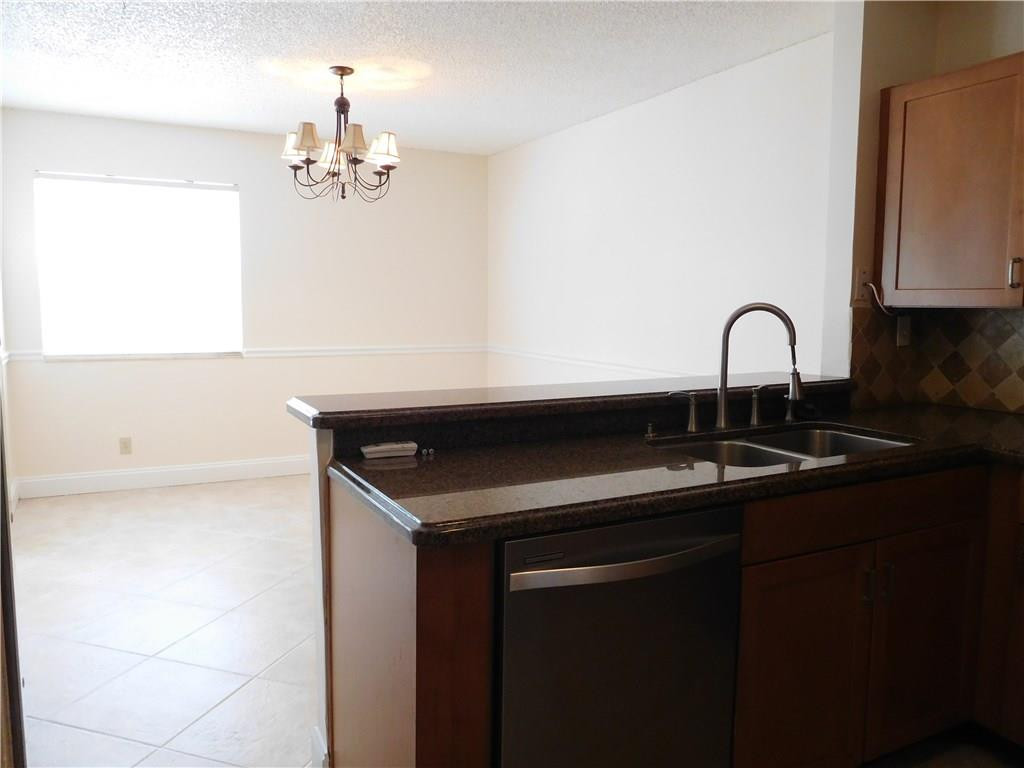 18897 Cloud Lake Circle Boca Raton, FL 33496 - Photo 6 of 23 a kitchen with a sink and a potted plant