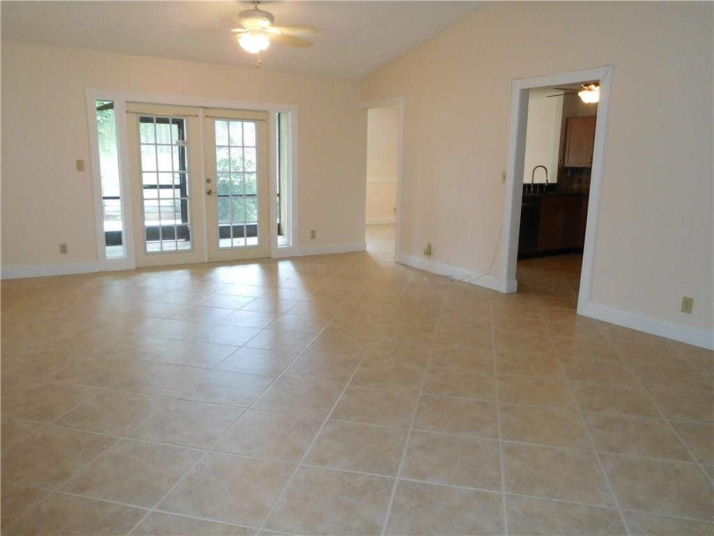 18897 Cloud Lake Circle Boca Raton, FL 33496 - Photo 8 of 23 an empty room with floor to ceiling windows and chandelier