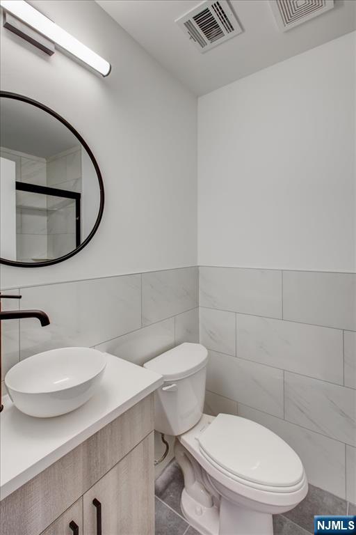 581 Bergen Street Newark, NJ 07108 - Photo 20 of 21 a white toilet sitting next to a bathroom sink