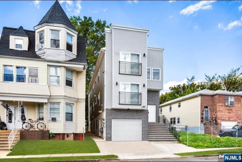 581 Bergen Street Newark, NJ 07108 - Photo 2 of 21 a front view of a house with a yard