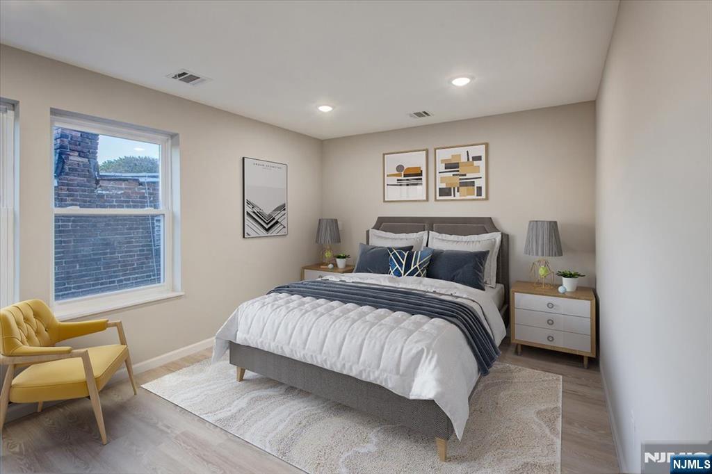 581 Bergen Street Newark, NJ 07108 - Photo 3 of 21 a spacious bedroom with a bed and glass window