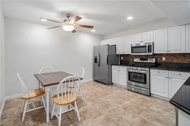 a kitchen with a refrigerator stove and microwave