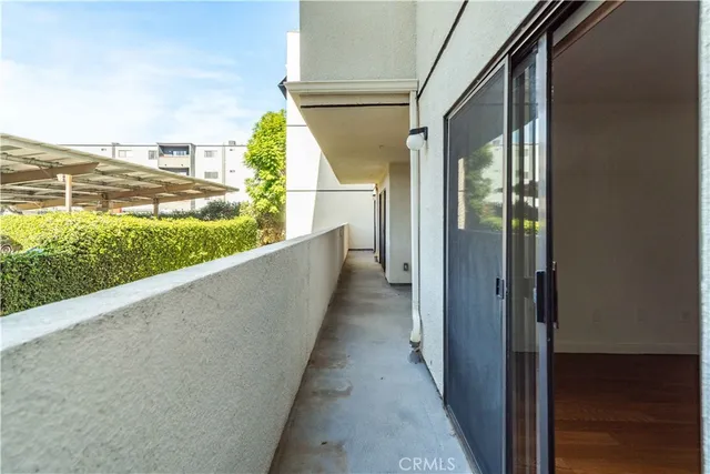an empty room with wooden floor and sliding door