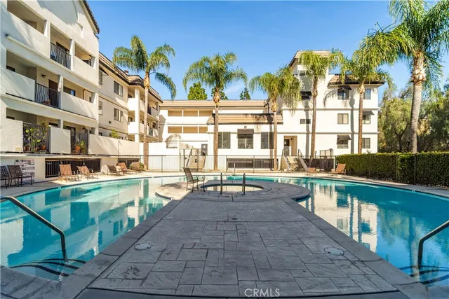 a view of a swimming pool with outdoor seating
