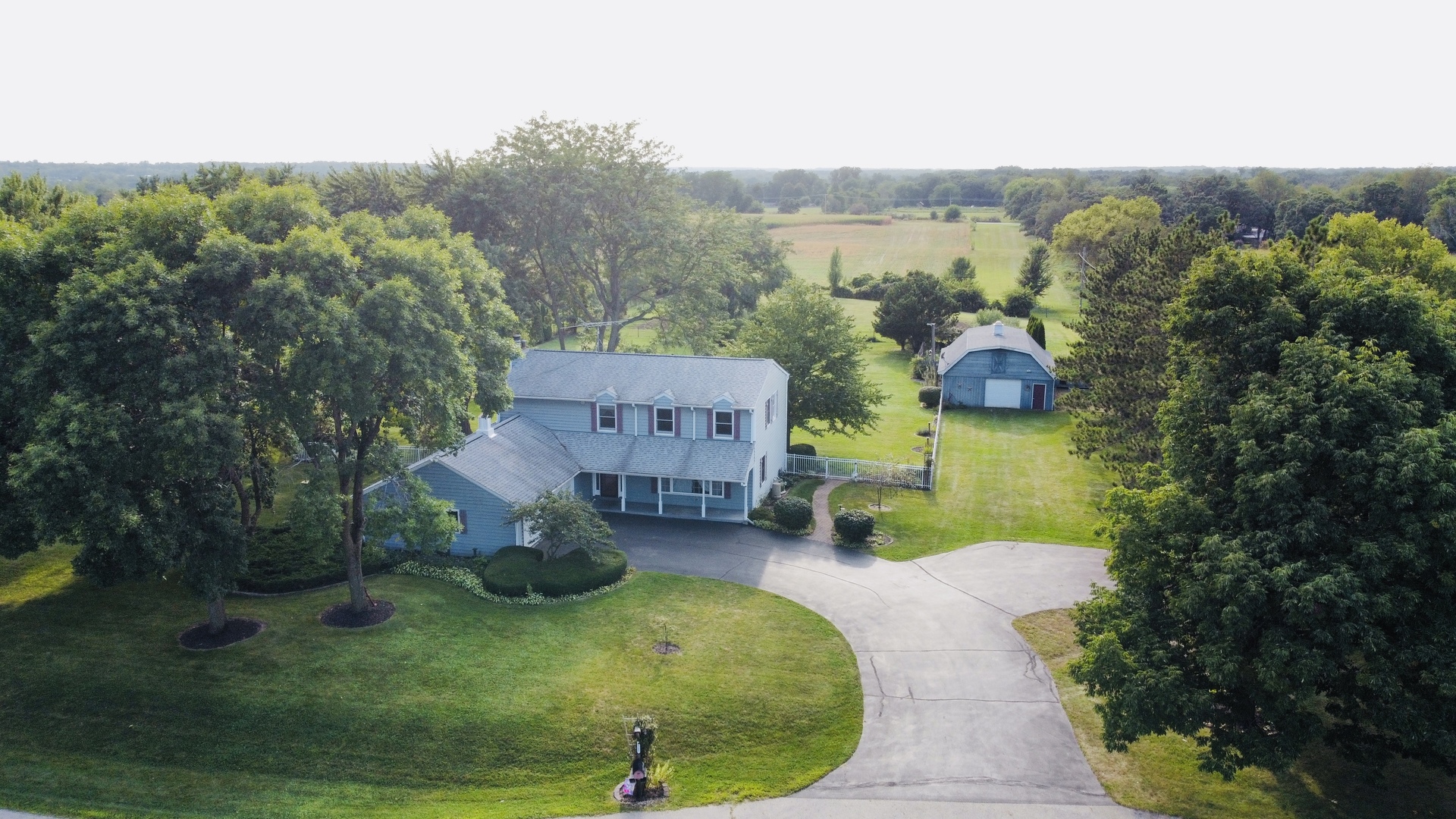 an aerial view of a house with garden space and street view