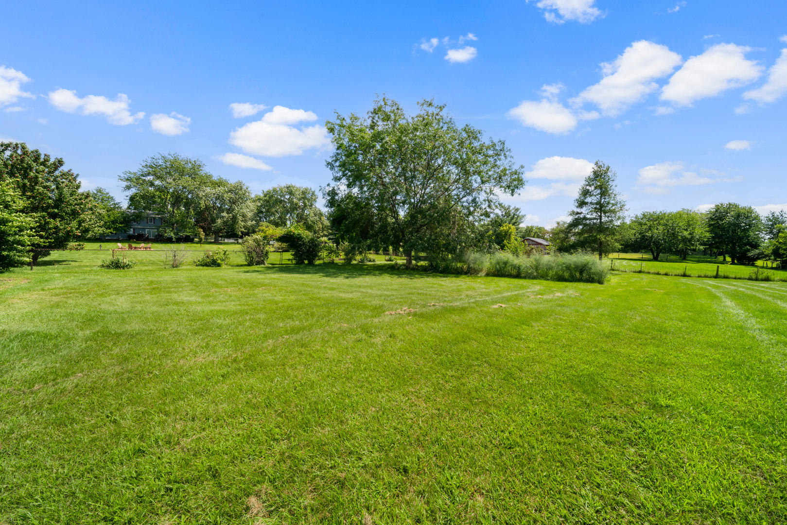 8515 Schmidt Street Spring Grove, IL 60081 - Photo 13 of 43 a view of a golf course with a lake