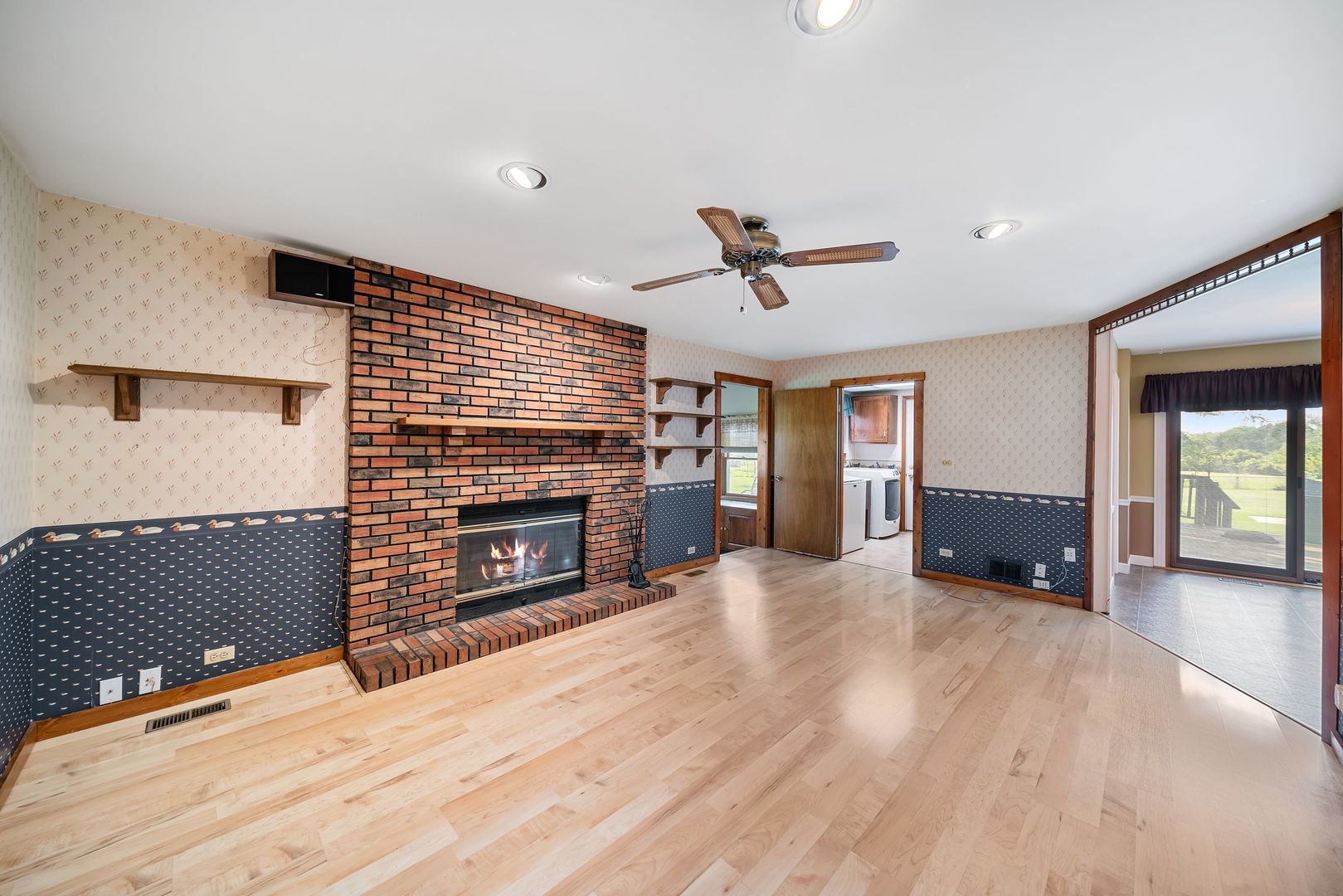 8515 Schmidt Street Spring Grove, IL 60081 - Photo 19 of 43 a view of an empty room with a fireplace and a window