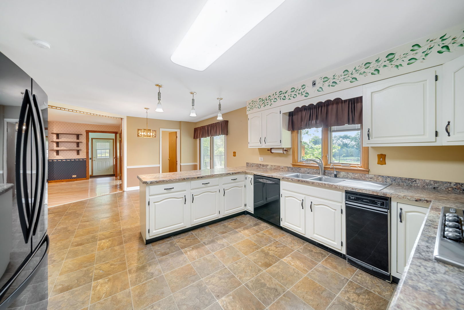 8515 Schmidt Street Spring Grove, IL 60081 - Photo 21 of 43 a large kitchen with granite countertop a stove a sink dishwasher and a refrigerator