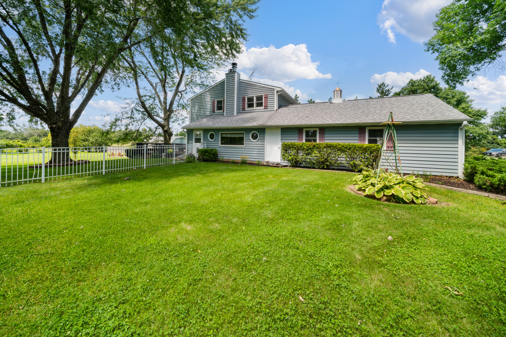 8515 Schmidt Street Spring Grove, IL 60081 - Photo 29 of 43 a front view of a house with garden
